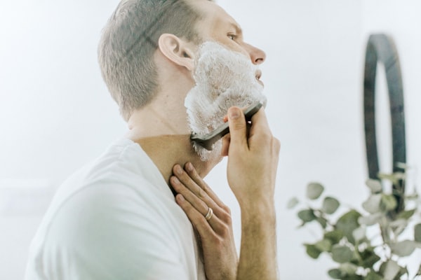 Man shaving with a safety razor, men's grooming gift for Father's Day