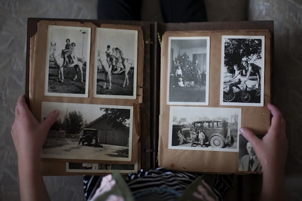 Person opening a photo album with memories, personalized Father's Day gift